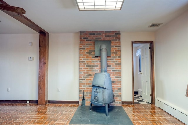 248 Spruceton Ave, Mt Lebanon, PA 15228 - living room featuring visible vents, baseboards, a wood stove, brick floor, and a baseboard heating unit