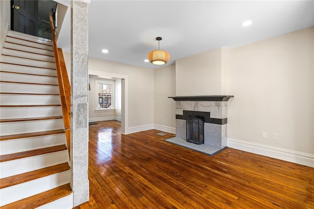 927 Greenfield Ave, Greenfield, PA 15217 - unfurnished living room featuring recessed lighting, wood-type flooring, a fireplace, baseboards, and stairs