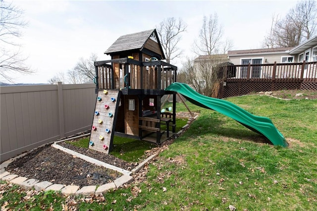 view of playground with a deck, a fenced backyard, and a lawn