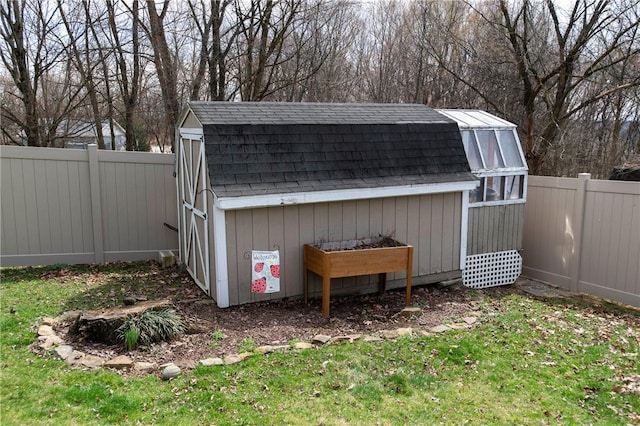 view of shed with a fenced backyard