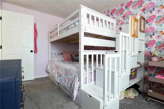 carpeted bedroom featuring wallpapered walls and baseboards