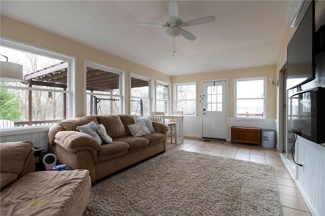 living area featuring light tile patterned flooring and a ceiling fan