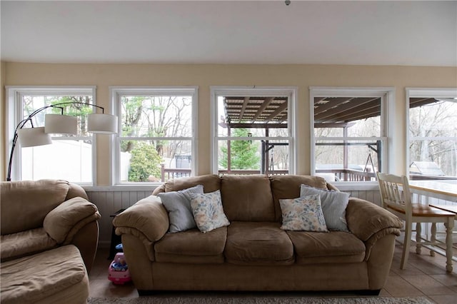living area featuring tile patterned flooring and plenty of natural light