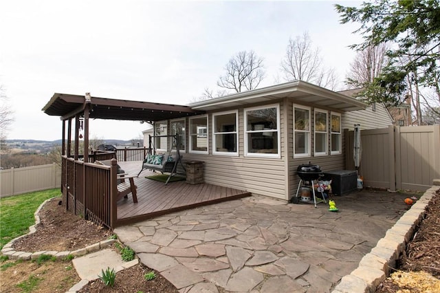 exterior space with a wooden deck and a fenced backyard