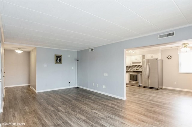 unfurnished living room featuring a ceiling fan, light wood-style flooring, baseboards, and visible vents