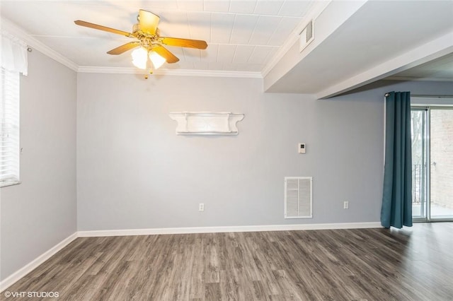 unfurnished room with visible vents, wood finished floors, and ornamental molding
