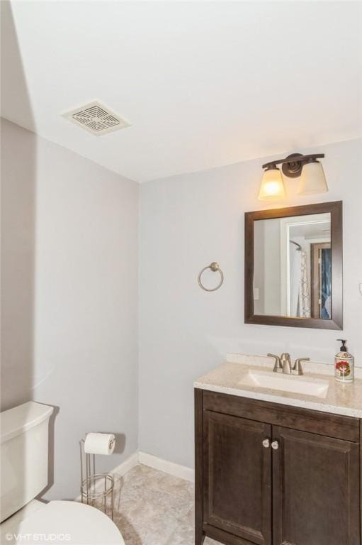 bathroom with visible vents, baseboards, toilet, and vanity