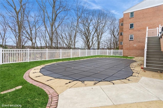 view of swimming pool with stairway, a patio area, and a fenced backyard