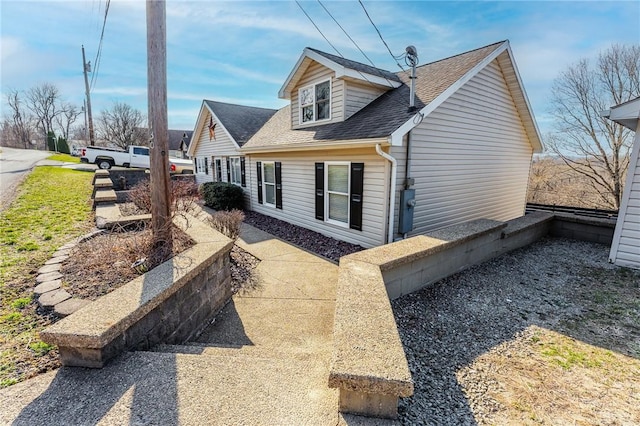 view of home's exterior featuring a shingled roof