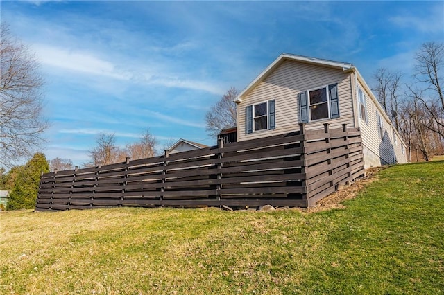 view of side of property with a yard
