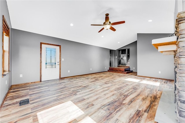 unfurnished living room featuring baseboards, lofted ceiling, a ceiling fan, and light wood finished floors
