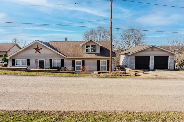 view of front of property with a detached garage and an outdoor structure