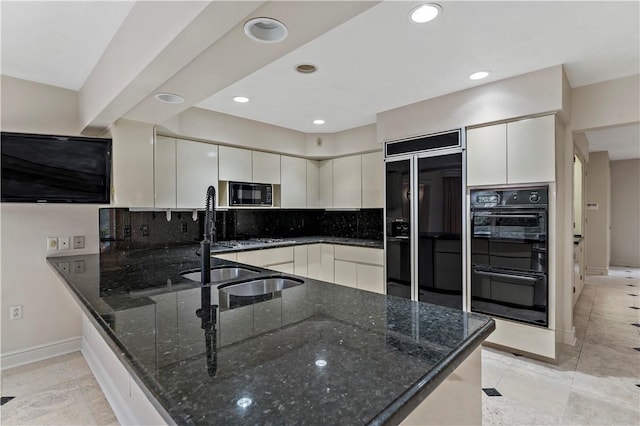 2172 Hycroft Dr, Upper St Clair, PA 15241 - kitchen with black appliances, dark stone countertops, a peninsula, baseboards, and backsplash