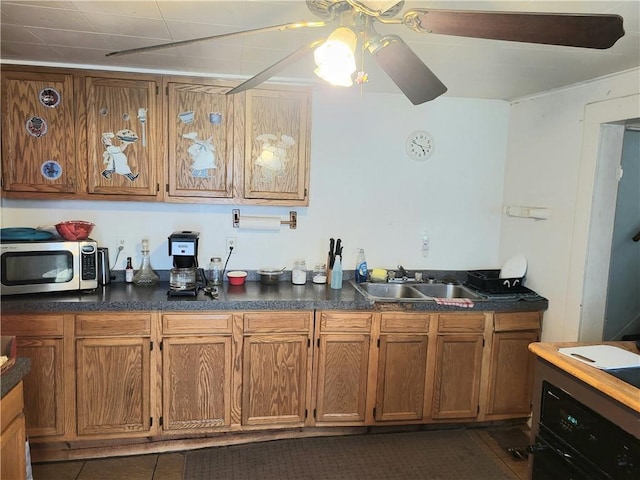 848 Arlington Ave, New Castle/5Th, PA 16101 - kitchen featuring stainless steel microwave, a sink, brown cabinetry, dark countertops, and ceiling fan