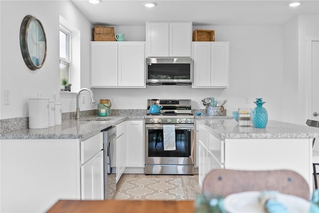 121 Samantha Dr, Center Twp, PA 15061 - kitchen with appliances with stainless steel finishes, white cabinets, light stone counters, and recessed lighting
