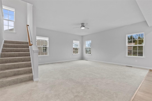 130 Arnoni Dr, Jefferson Hills, PA 15025 - unfurnished living room with baseboards, a ceiling fan, stairs, light wood-style floors, and light carpet