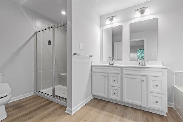 130 Arnoni Dr, Jefferson Hills, PA 15025 - bathroom featuring toilet, double vanity, a tile shower, and wood finished floors