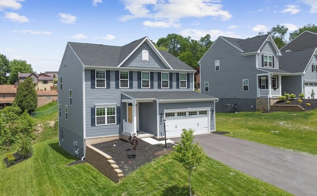 130 Arnoni Dr, Jefferson Hills, PA 15025 - view of front of house featuring driveway, an attached garage, a front lawn, central AC unit, and a shingled roof