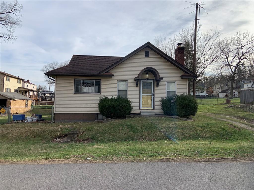 bungalow-style house with a front yard, fence, roof with shingles, and a chimney