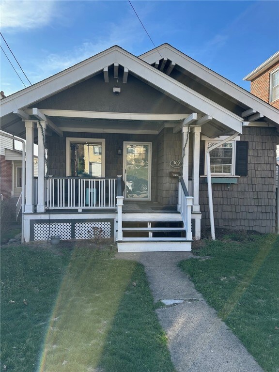 309 Marie St, Glassport, PA 15045 - view of front of home featuring a porch and a front lawn
