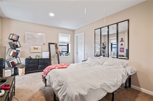 bedroom featuring baseboards and carpet