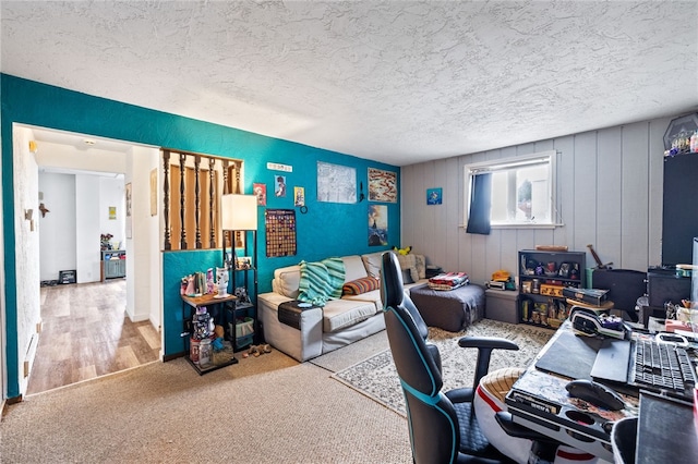 carpeted office space with a textured ceiling