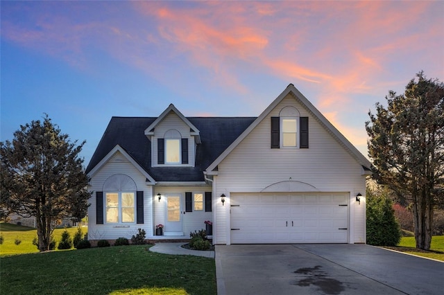 view of front of home featuring a lawn, an attached garage, and driveway