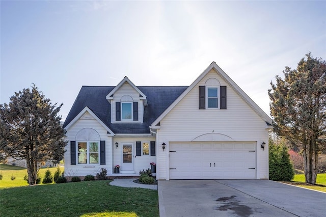 view of front of property with an attached garage, concrete driveway, and a front yard