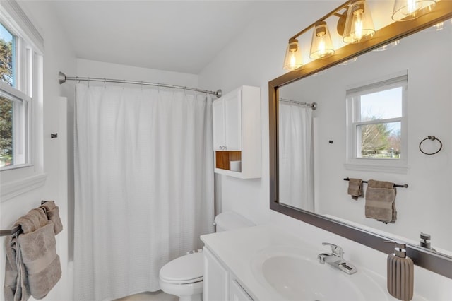 bathroom featuring vanity, toilet, and shower / tub combo with curtain