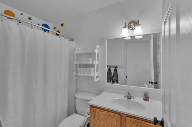 bathroom featuring vanity, curtained shower, and toilet