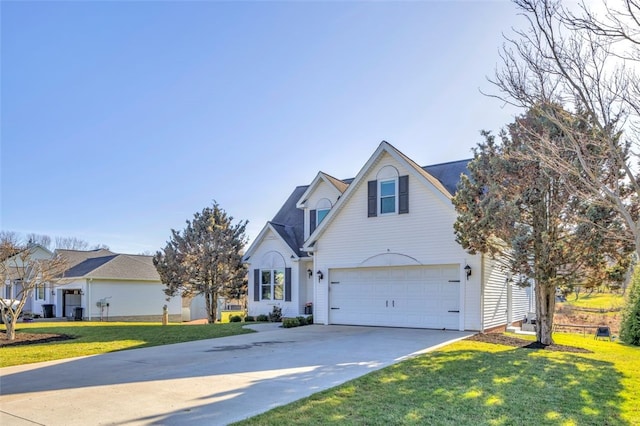 traditional-style home featuring a front lawn, an attached garage, and driveway