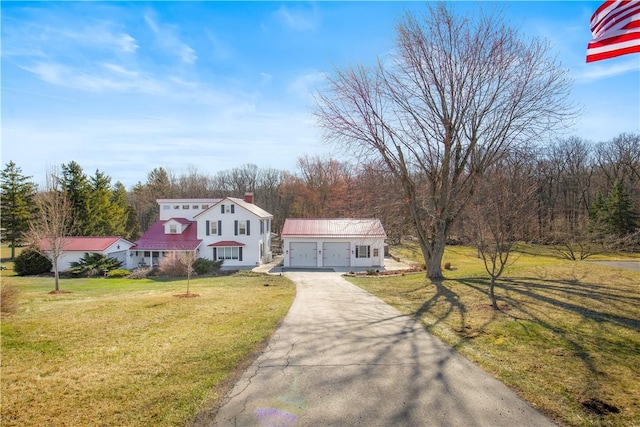 260 Stouffer Hill Rd, Somerset Twp, PA 15541 - view of front of house with an outbuilding, a front lawn, driveway, metal roof, and a garage