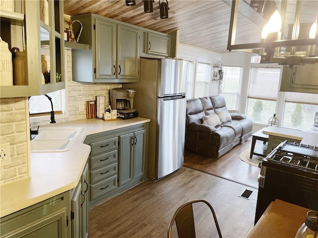 260 Stouffer Hill Rd, Somerset Twp, PA 15541 - kitchen with wood finished floors, freestanding refrigerator, a sink, black gas range, and wood ceiling