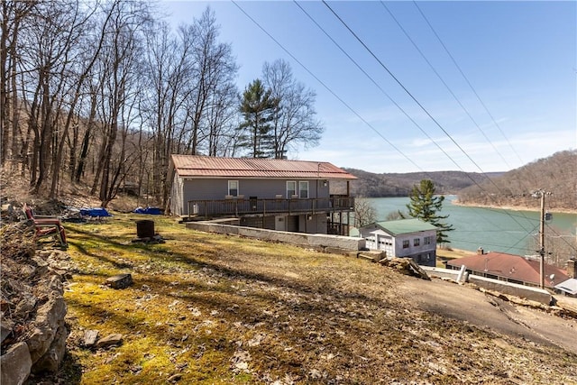 exterior space featuring a deck with water view