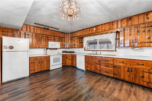 kitchen featuring brown cabinetry, white appliances, and light countertops