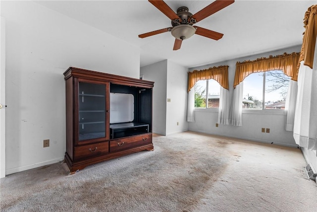 unfurnished living room featuring baseboards, ceiling fan, and carpet floors