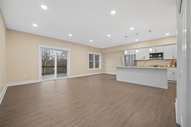 1223 Center Ave, West View, PA 15229 - unfurnished living room featuring recessed lighting, dark wood-style floors, baseboards, and a sink