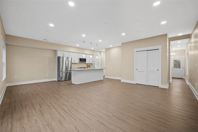 1223 Center Ave, West View, PA 15229 - unfurnished living room with a sink, recessed lighting, baseboards, and wood finished floors