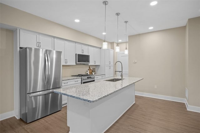 1223 Center Ave, West View, PA 15229 - kitchen with a sink, a center island with sink, stainless steel appliances, white cabinetry, and dark wood-style flooring