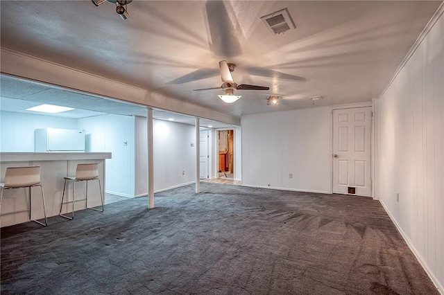 159 Mardi Gras Dr, Plum Boro, PA 15239 - unfurnished living room featuring visible vents, baseboards, a ceiling fan, and dark colored carpet