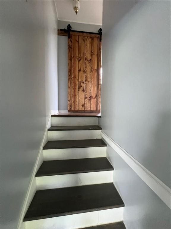 stairs featuring a barn door
