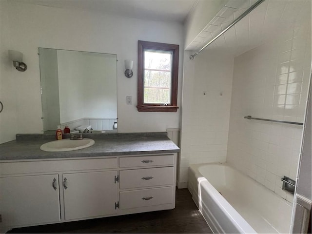 bathroom with vanity, shower / bathtub combination, and wood finished floors