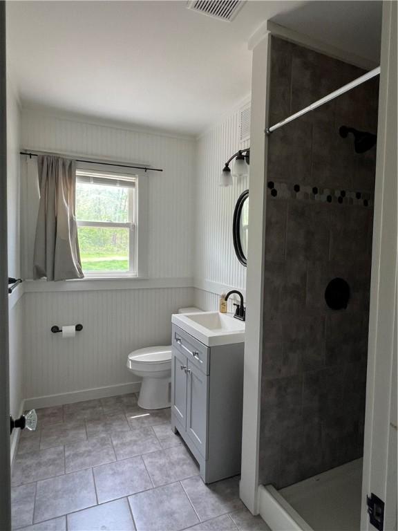 full bath with vanity, toilet, tile patterned floors, visible vents, and a stall shower