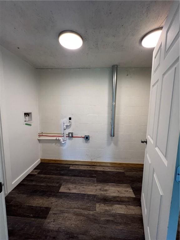 clothes washing area featuring baseboards, laundry area, wood finished floors, and hookup for a washing machine