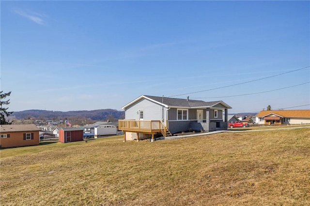 667 Memorial Dr, Plum Boro, PA 15068 - rear view of house with a storage unit, an outdoor structure, a lawn, and a deck