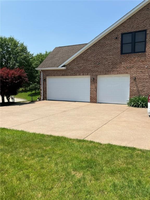 123 Windermere Ct, Peters Twp, PA 15317 - view of side of property featuring brick siding, a garage, and a lawn