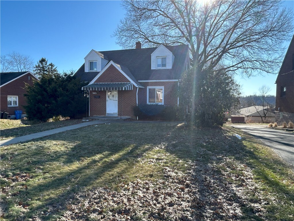 2768 Grant St, Lower Burrell, PA 15068 - view of front of property with brick siding, a chimney, and a front yard