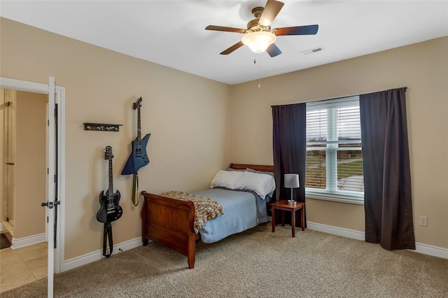 bedroom with baseboards, visible vents, a ceiling fan, and light colored carpet