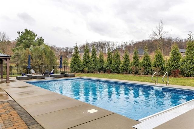 view of swimming pool featuring fence, a patio, an outdoor living space with a fire pit, a fenced in pool, and a lawn