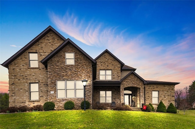 view of front of property featuring brick siding and a front lawn